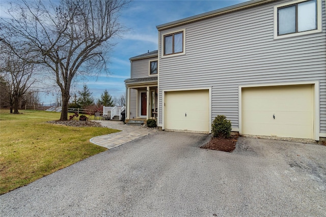 view of home's exterior with a lawn and a garage