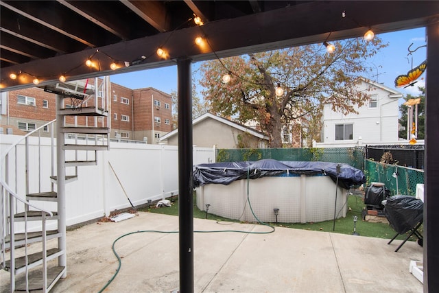 view of patio featuring a covered pool