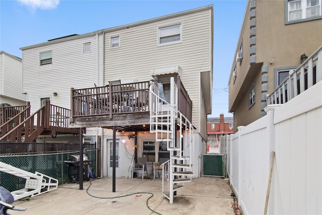 back of house with a patio and a deck