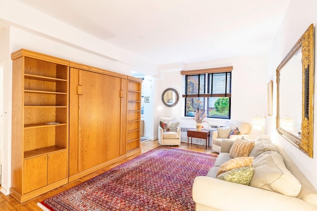 living area featuring hardwood / wood-style flooring and radiator