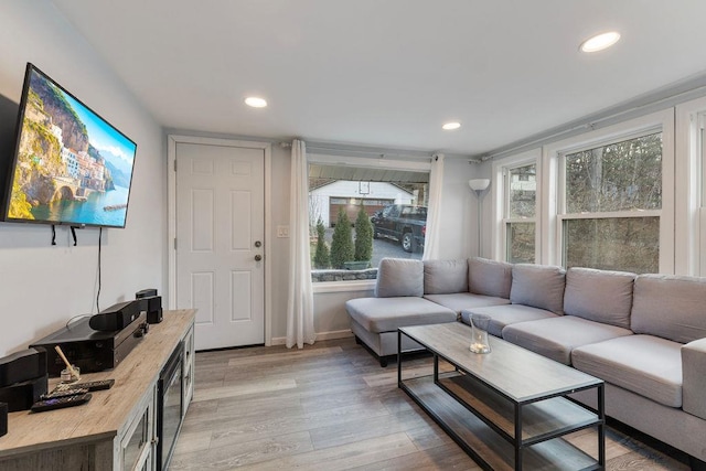 living room with plenty of natural light and light wood-type flooring