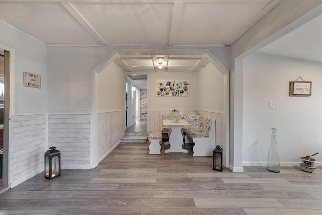 interior space with beamed ceiling and light hardwood / wood-style floors