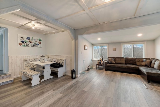 living room with hardwood / wood-style flooring, beamed ceiling, wooden walls, and coffered ceiling