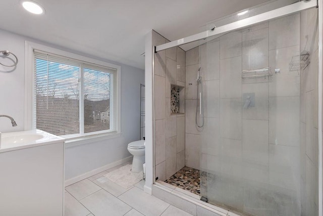 bathroom with tile patterned flooring, vanity, toilet, and walk in shower