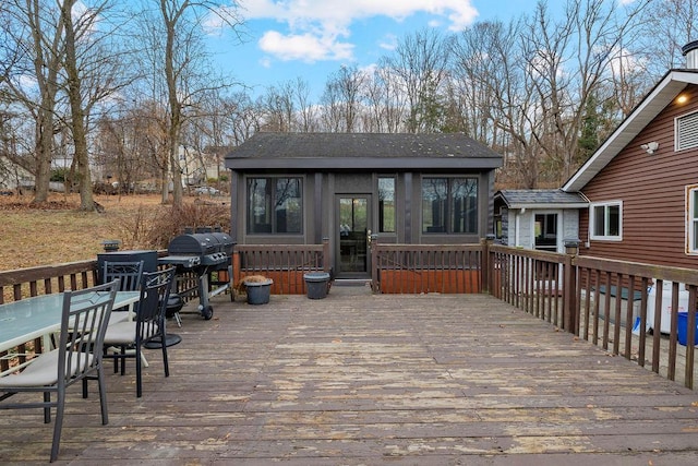 wooden terrace with grilling area and a sunroom