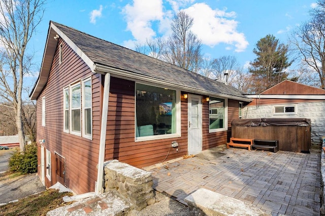 exterior space featuring a patio and a hot tub