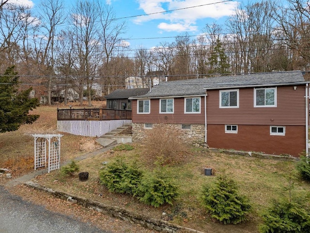 view of side of property with a wooden deck