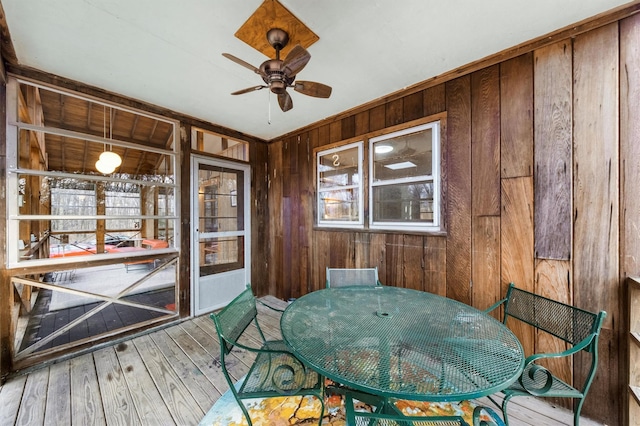 unfurnished sunroom with ceiling fan and a healthy amount of sunlight