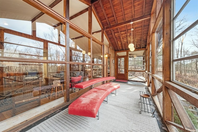 unfurnished sunroom featuring lofted ceiling with beams and wooden ceiling