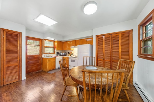 dining area with plenty of natural light, a baseboard radiator, dark hardwood / wood-style floors, and sink