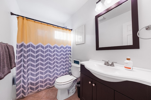 bathroom featuring toilet, tile patterned flooring, vanity, and walk in shower