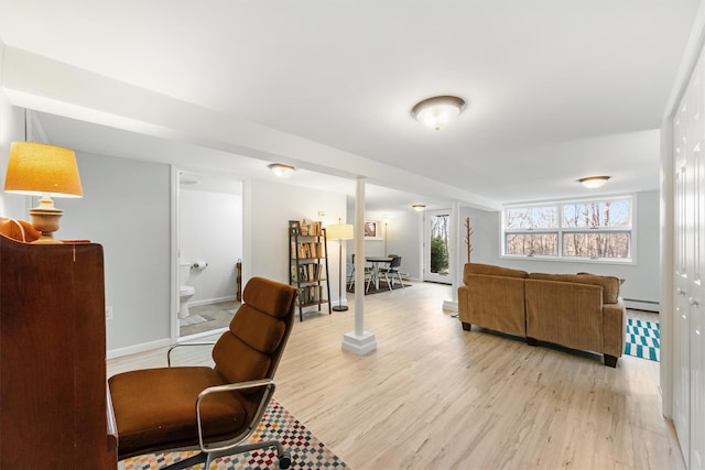 living room with light wood-type flooring and a baseboard radiator