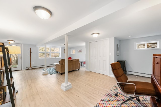 office area with a baseboard radiator and light hardwood / wood-style floors