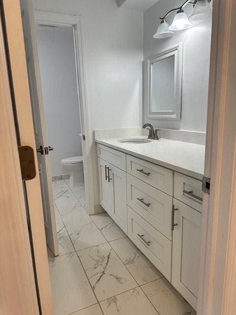 bathroom featuring vanity and toilet