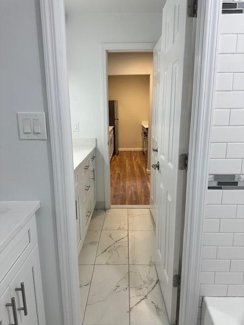 bathroom with a bathtub, vanity, and hardwood / wood-style flooring