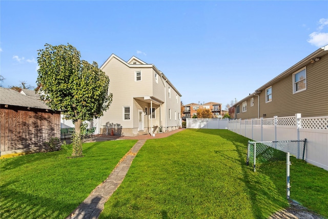 rear view of property with a yard