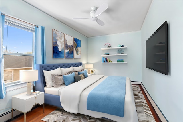 bedroom with ceiling fan, dark hardwood / wood-style floors, and a baseboard radiator