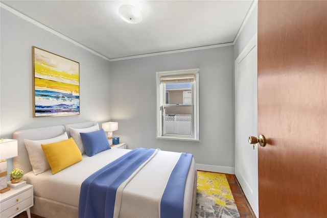 bedroom featuring crown molding and dark wood-type flooring