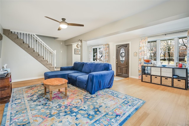 living room with plenty of natural light, ceiling fan, and wood-type flooring