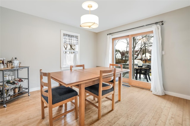 dining space with light wood-type flooring