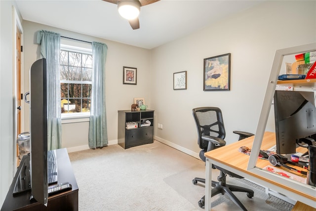 carpeted office space featuring ceiling fan