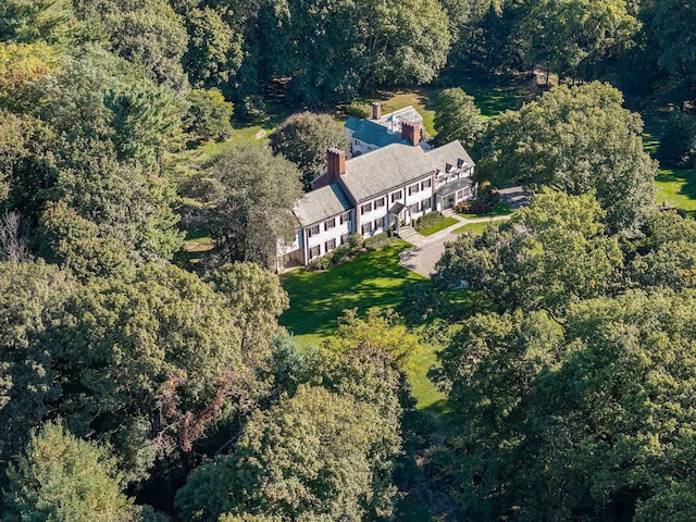 bird's eye view with a wooded view