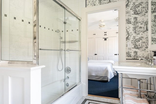 ensuite bathroom with wallpapered walls, ensuite bath, combined bath / shower with glass door, and a sink