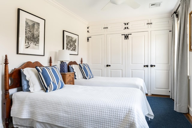 bedroom with crown molding, visible vents, ceiling fan, and a closet