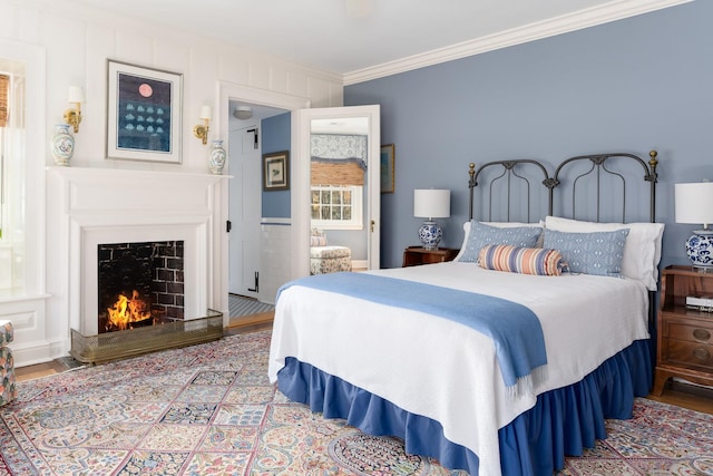177 Old Briarcliff Rd, Briarcliff Manor, NY 10510 - bedroom with crown molding, wood finished floors, and a lit fireplace