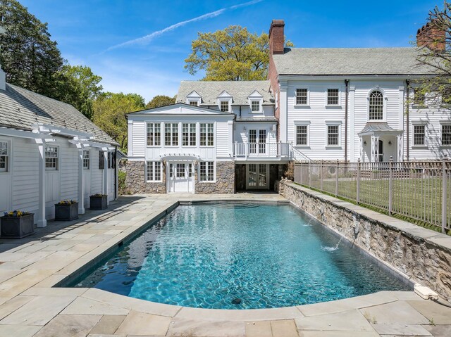 177 Old Briarcliff Rd, Briarcliff Manor, NY 10510 - rear view of property with fence, a pergola, stone siding, a chimney, and a patio area