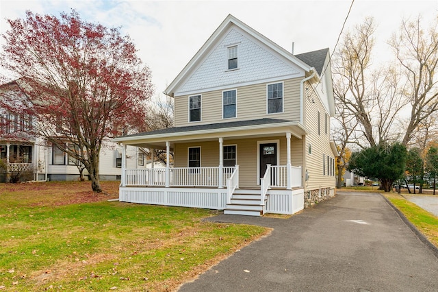 view of front facade with a front yard and a porch