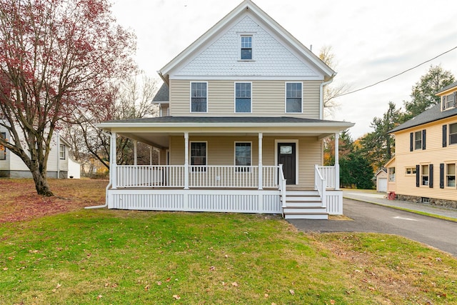 view of front of property with covered porch and a front yard