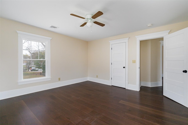 unfurnished bedroom featuring ceiling fan and dark wood-type flooring