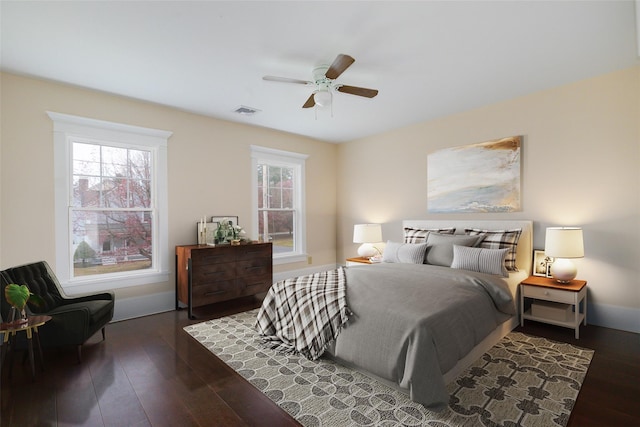 bedroom with dark hardwood / wood-style floors and ceiling fan