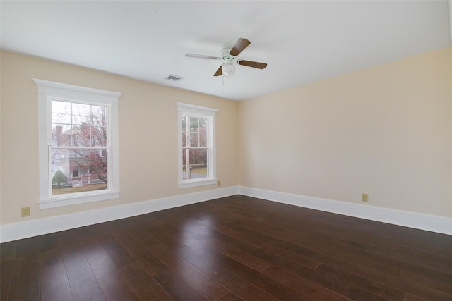 spare room featuring ceiling fan and dark wood-type flooring