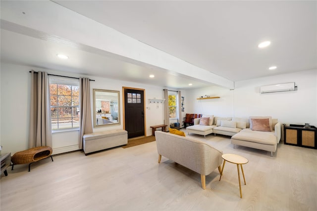 living room with a wall mounted AC and light wood-type flooring