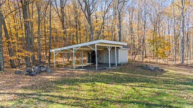 view of yard with an outdoor structure and a carport