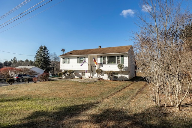 bi-level home with a front lawn