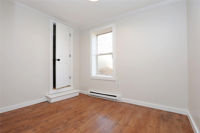 empty room with light wood-type flooring, a baseboard radiator, baseboards, and crown molding