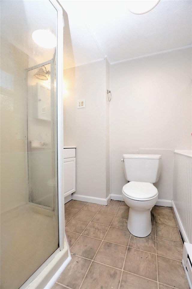 full bathroom with a baseboard heating unit, baseboards, toilet, a stall shower, and tile patterned floors