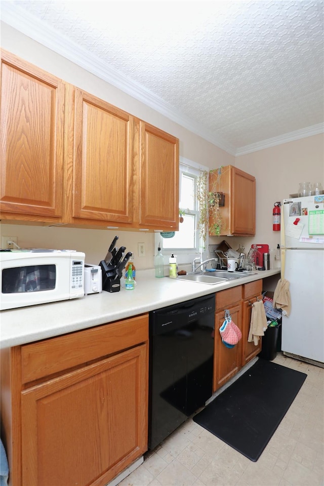 kitchen featuring ornamental molding, a sink, white appliances, light countertops, and light floors