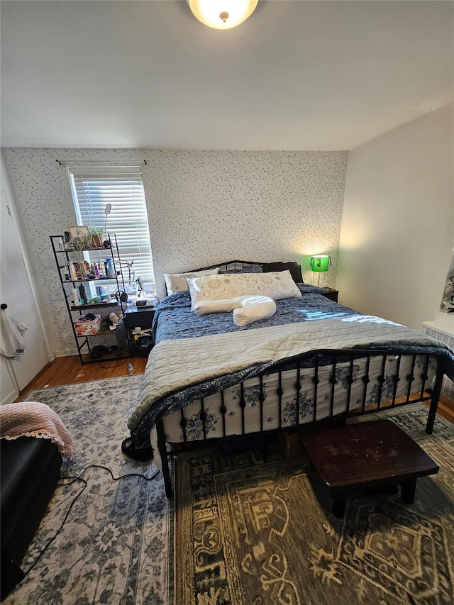 bedroom with hardwood / wood-style flooring