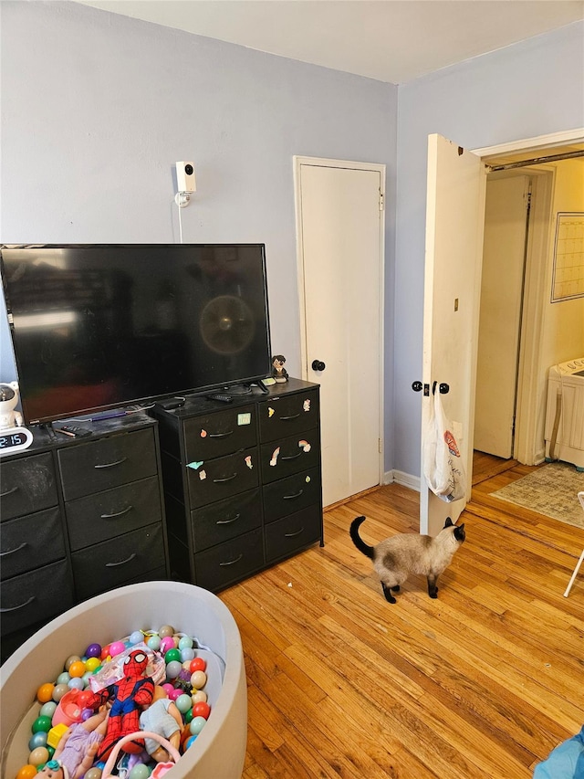 interior space featuring wood-type flooring and washer / dryer