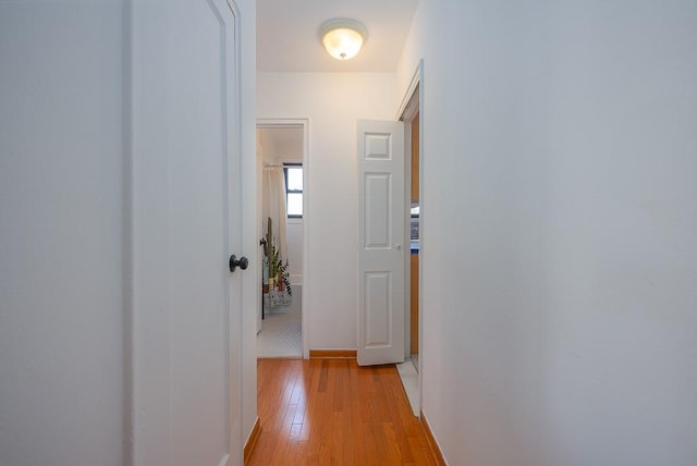 hall with light hardwood / wood-style floors