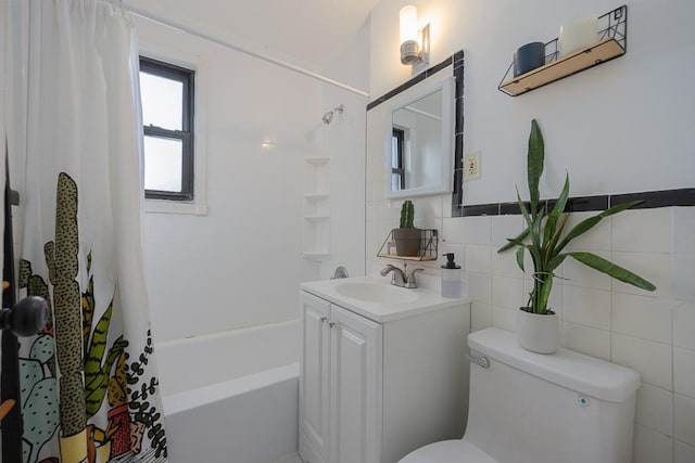 full bathroom with shower / tub combo with curtain, vanity, tile walls, and toilet