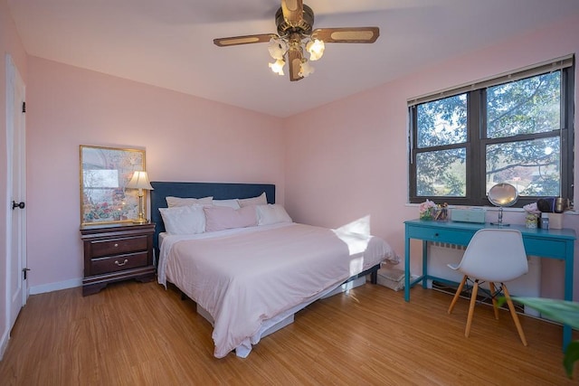 bedroom with light wood-type flooring and ceiling fan