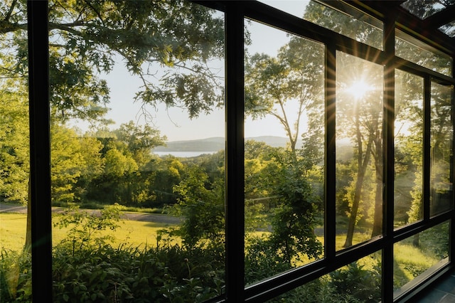 unfurnished sunroom featuring a water view