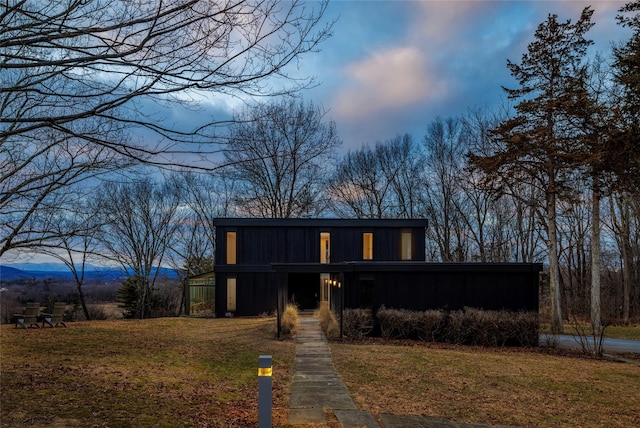 contemporary house with a yard and a mountain view