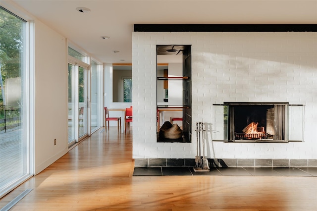 living room featuring hardwood / wood-style floors, a fireplace, and expansive windows