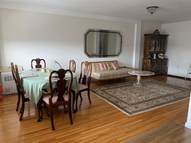 dining room with radiator and light hardwood / wood-style flooring